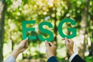 Hands of business team holding ESG text, Environmental, social and corporate governance concept.