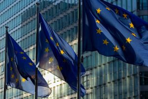 EU flags waving in front of the European Commission building in Brussels, Belgium.